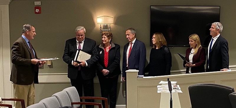 Representing his sister Assemblywoman Claire Swift, attorney James P. Swift presents a Legislative Commendation to Joseph Sayegh and John Rosenberger.