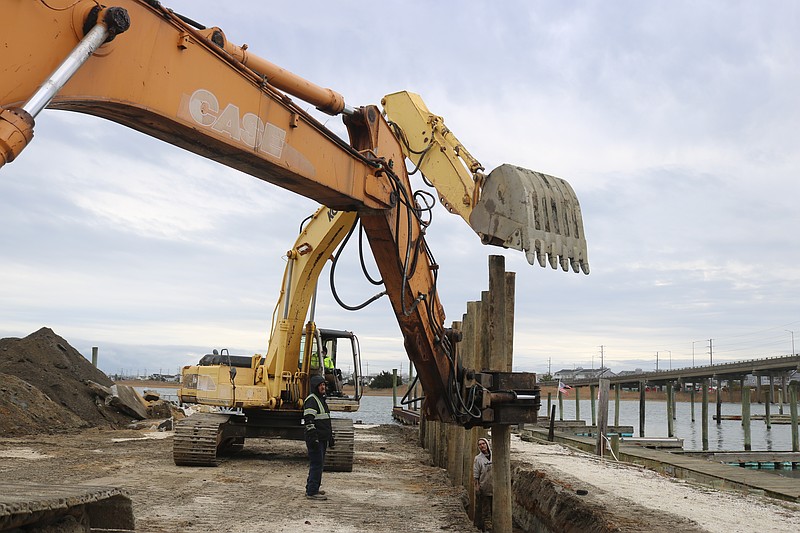 Heavy construction machinery is being used to build a series of new seawalls at the marina.