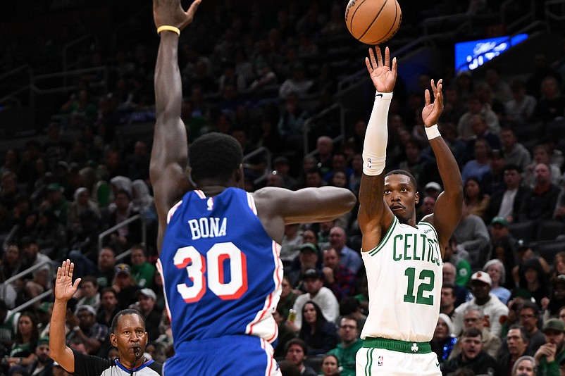 Oct 12, 2024; Boston, Massachusetts, USA; Boston Celtics guard Lonnie Walker IV (12) attempts a basket against Philadelphia 76ers center Adem Bona (30) during the second half at the TD Garden. Mandatory Credit: Brian Fluharty-Imagn Images