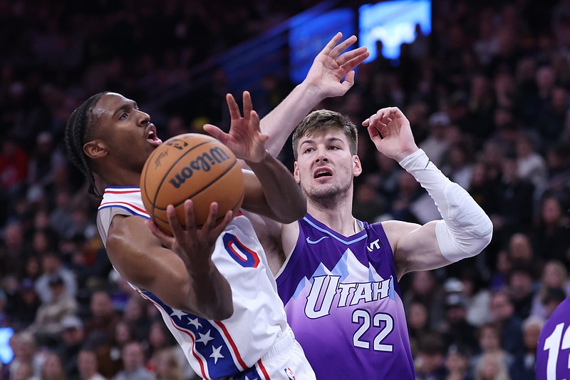 Dec 28, 2024; Salt Lake City, Utah, USA; Philadelphia 76ers guard Tyrese Maxey (0) goes to the basket against Utah Jazz forward Kyle Filipowski (22) during the second quarter at Delta Center. Mandatory Credit: Rob Gray-Imagn Images