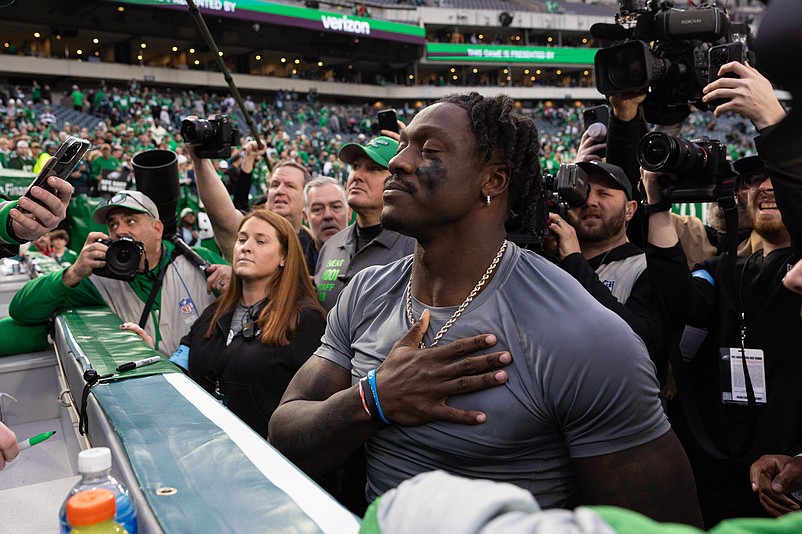 Dec 29, 2024; Philadelphia, Pennsylvania, USA; Philadelphia Eagles wide receiver A.J. Brown thanks a fan for returning the first NFL touchdown pass of quarterback Tanner McKee (not pictured) after a victory against the Dallas Cowboys at Lincoln Financial Field. Mandatory Credit: Bill Streicher-Imagn Images