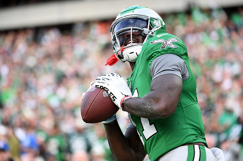 Dec 29, 2024; Philadelphia, Pennsylvania, USA; Philadelphia Eagles wide receiver A.J. Brown (11) throws the football into the stands after scoring a touchdown  during the third quarter against the Dallas Cowboys at Lincoln Financial Field. Mandatory Credit: Eric Hartline-Imagn Images