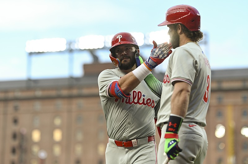 Jun 14, 2024; Baltimore, Maryland, USA;  Philadelphia Phillies designated hitter Kyle Schwarber (12) celebrates with  first baseman Bryce Harper (3) after hitting a first inning solo home run against the Baltimore Orioles at Oriole Park at Camden Yards. Mandatory Credit: Tommy Gilligan-USA TODAY Sports