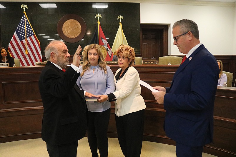 Board of Commissioners Director Leonard Desiderio is joined by his wife and daughter, both named Carmela, while taking the oath of office from Michael Donohue.