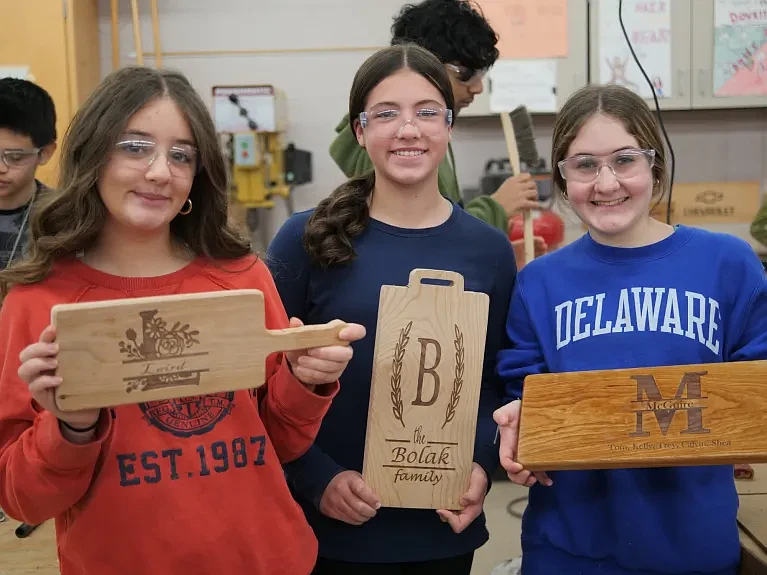 Eighth grade Pennridge students display their customized cutting boards. (Credit: David Thomas)