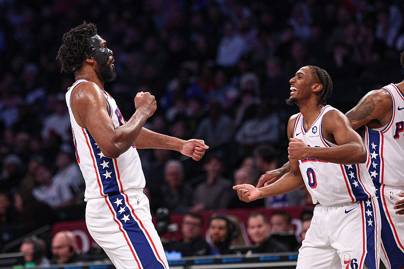 Jan 4, 2025; Brooklyn, New York, USA; Philadelphia 76ers center Joel Embiid (21) celebrates with guard Tyrese Maxey (0) during the first half against the Brooklyn Nets at Barclays Center. Mandatory Credit: Vincent Carchietta-Imagn Images