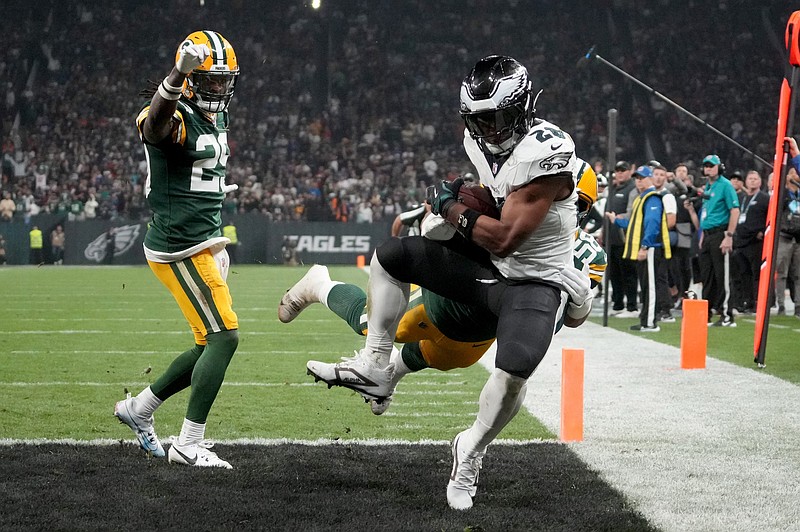 Sep 6, 2024; Sao Paulo, BRA; Philadelphia Eagles running back Saquon Barkley (26) catches a touchdown against Green Bay Packers linebacker Isaiah McDuffie (58) and safety Xavier McKinney (29) during the second quarter at Neo Quimica Arena. Mandatory Credit: Kirby Lee-Imagn Images