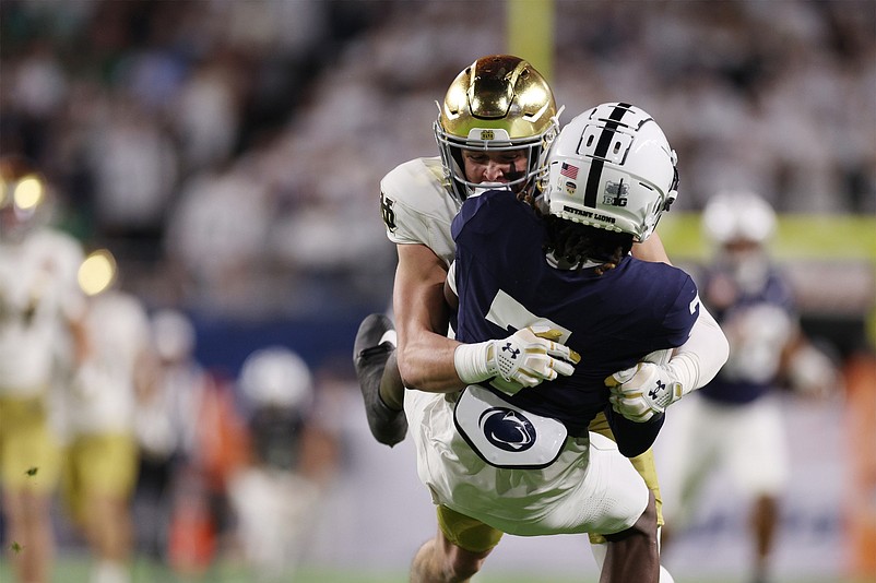 Jan 9, 2025; Miami, FL, USA; Notre Dame Fighting Irish safety Luke Talich (28) tackles Penn State Nittany Lions wide receiver Kaden Saunders (7) during a kick off return in the second half at Hard Rock Stadium. Mandatory Credit: Nathan Ray Seebeck-Imagn Images