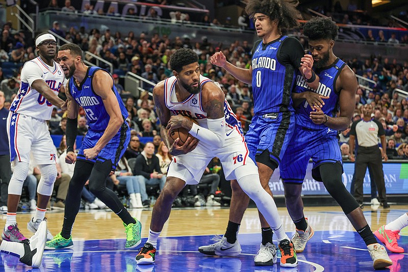 Jan 12, 2025; Orlando, Florida, USA; Philadelphia 76ers forward Paul George (8) grabs the rebound during the second half against the Orlando Magic at Kia Center. Mandatory Credit: Mike Watters-Imagn Images