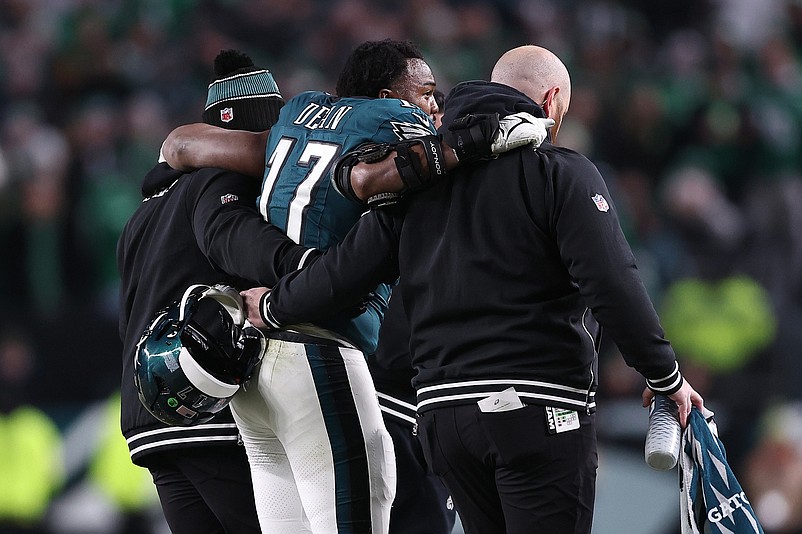 Jan 12, 2025; Philadelphia, Pennsylvania, USA; Philadelphia Eagles linebacker Nakobe Dean (17) is helped off the field against the Green Bay Packers during the first half in an NFC wild card game at Lincoln Financial Field. Mandatory Credit: Bill Streicher-Imagn Images