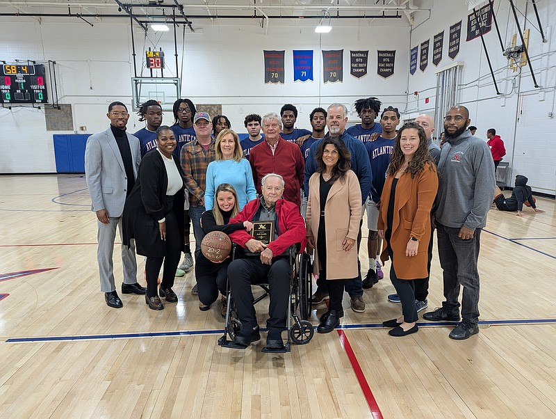 ATLANTIC CAPE/Former Atlantic Cape Men's Basketball Head Coach and College Administrator Robert Goudie is surrounded by his children, granddaughter, and members of Atlantic Cape and its Buccaneers Men's Basketball team.