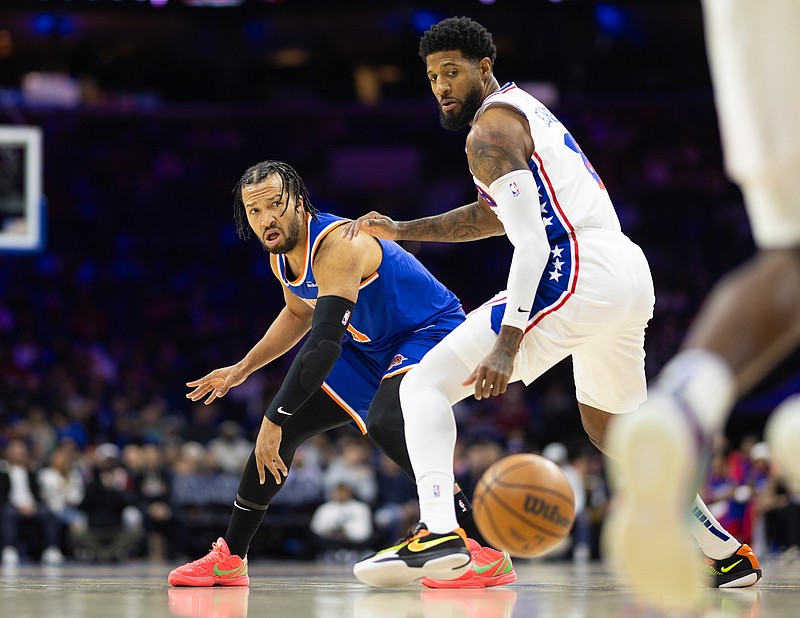 Jan 15, 2025; Philadelphia, Pennsylvania, USA; New York Knicks guard Jalen Brunson (11) passes the ball past Philadelphia 76ers forward Paul George (8) during the first quarter at Wells Fargo Center. Mandatory Credit: Bill Streicher-Imagn Images