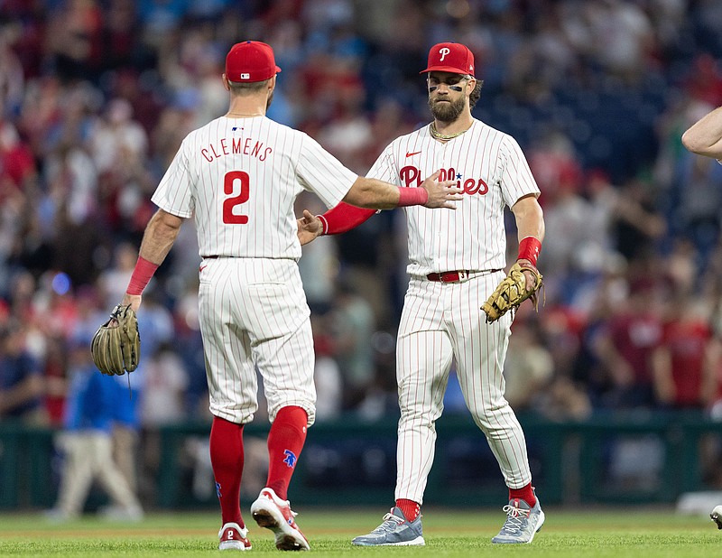 May 7, 2024; Philadelphia, Pennsylvania, USA;  Philadelphia Phillies first base Bryce Harper (3) and short stop Kody Clemens (2) shake hands after a victory against the Toronto Blue Jays at Citizens Bank Park. Mandatory Credit: Bill Streicher-USA TODAY Sports