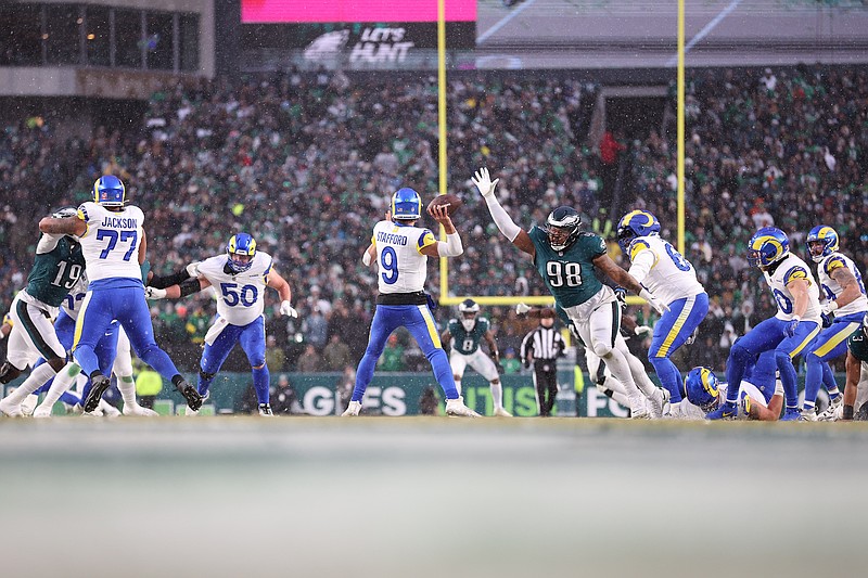 Jan 19, 2025; Philadelphia, Pennsylvania, USA; Los Angeles Rams quarterback Matthew Stafford (9) throws the ball as Philadelphia Eagles defensive tackle Jalen Carter (98) defends in the second quarter in a 2025 NFC divisional round game at Lincoln Financial Field. Mandatory Credit: Bill Streicher-Imagn Images