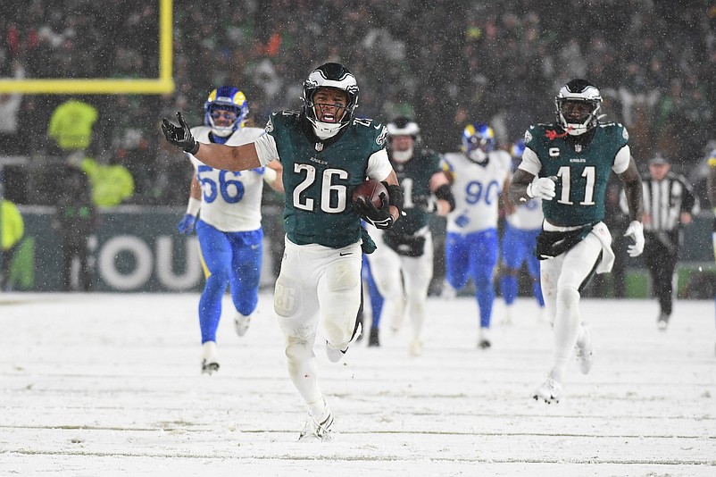 Jan 19, 2025; Philadelphia, Pennsylvania, USA; Philadelphia Eagles running back Saquon Barkley (26) carries the ball to score a touchdown against the Los Angeles Rams in the second half in a 2025 NFC divisional round game at Lincoln Financial Field. Mandatory Credit: Eric Hartline-Imagn Images