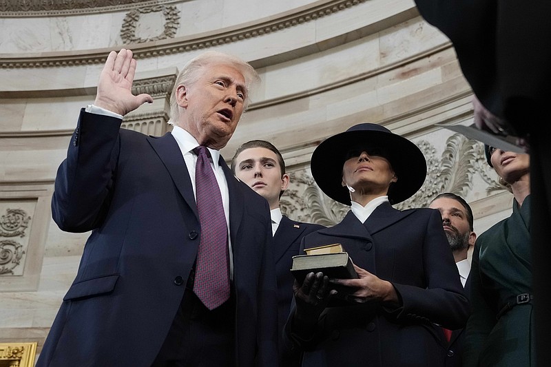 Jan 20, 2025; Washington, DC, USA; Donald Trump takes the oath during the 60th Presidential Inauguration in the Rotunda of the U.S. Capitol in Washington, Monday, Jan. 20, 2025. Mandatory Credit: Morry Gash-Pool via Imagn Images