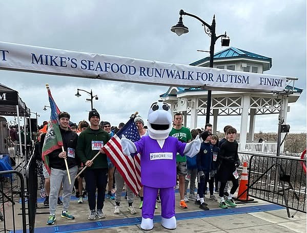 Shore Medical Center's mascot, Fin the Dolphin, joins participants at the start line of Mike's Seafood Run-Walk for Autism in 2024. (Photo courtesy of Shore Medical Center.