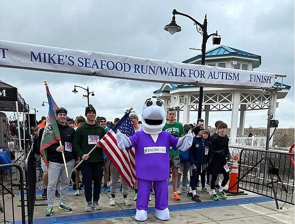 Shore Medical Center's mascot, Fin the Dolphin, joins participants at the start line of Mike's Seafood Run-Walk for Autism in 2024. (Photo courtesy of Shore Medical Center.