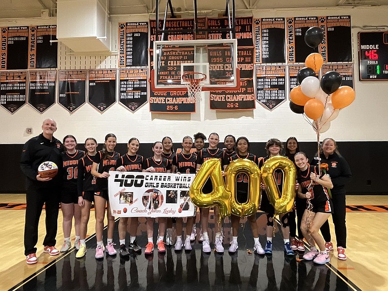 Coach John Leahy and his players celebrate his milestone. (Photo courtesy of Middle Township High School)