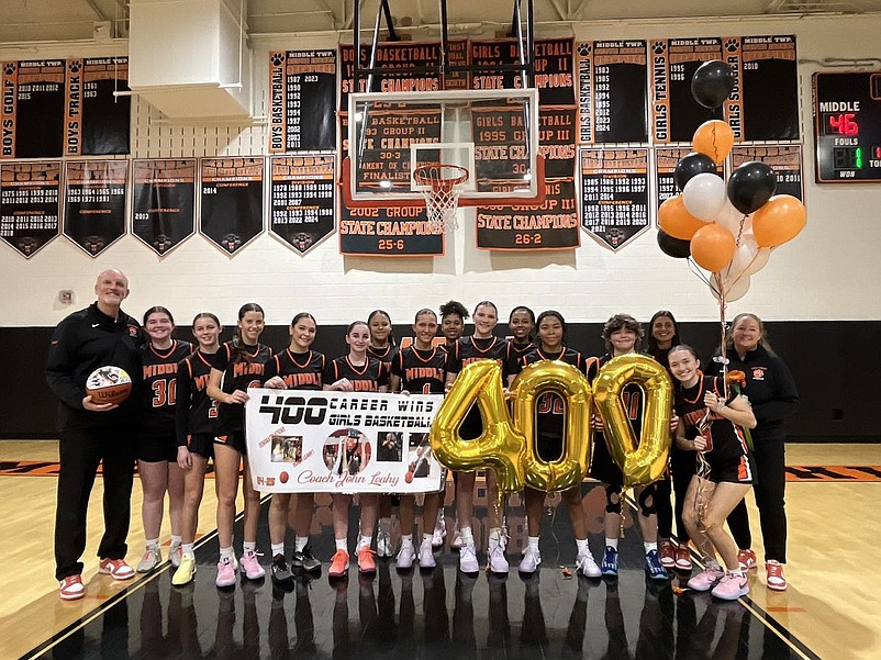 Coach John Leahy and his players celebrate his milestone. (Photo courtesy of Middle Township High School)
