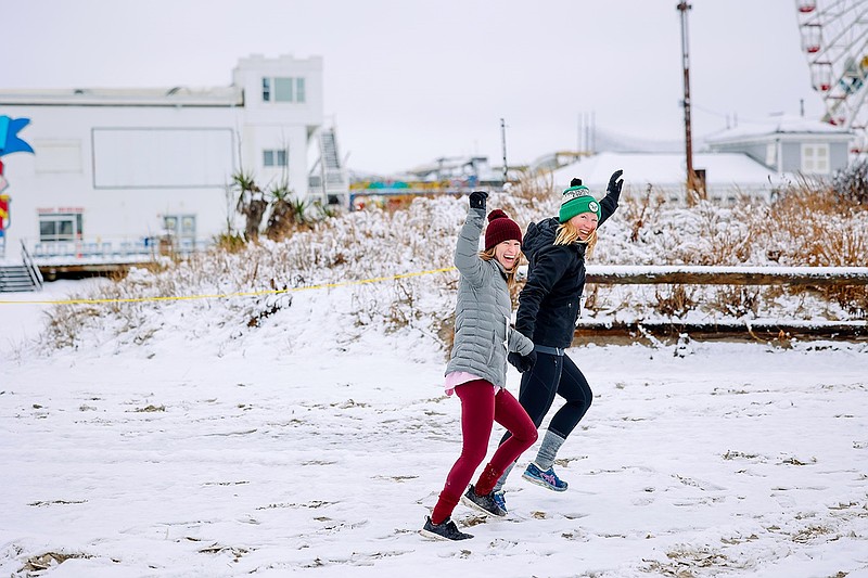 Competitors in the Winter Warrior Challenge run on a snowy beach. (Photo courtesy of Ocean City)