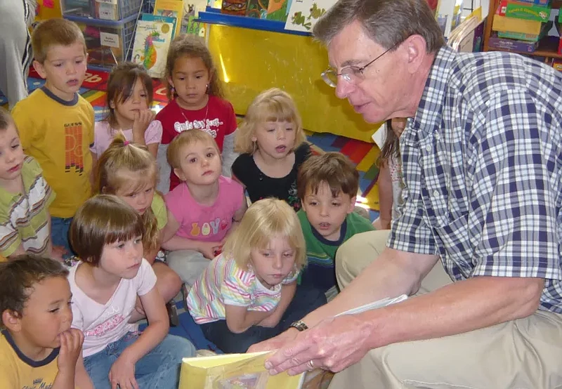 A volunteer reads to preschoolers through RSVP’s Family Literacy Program. (Credit: RSVP)