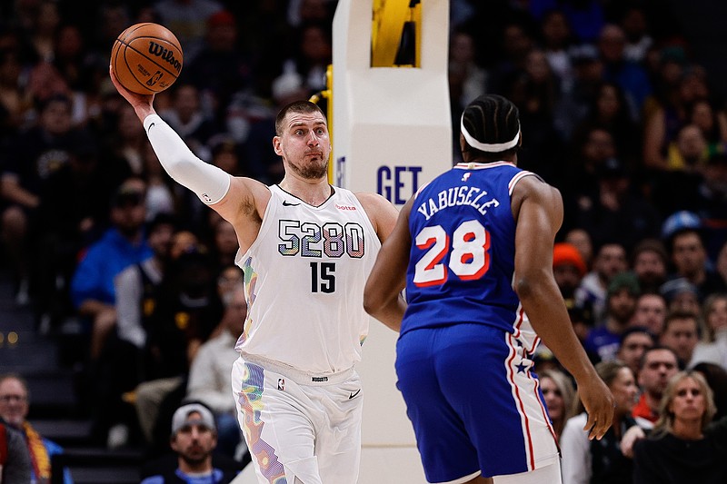 Jan 21, 2025; Denver, Colorado, USA; Denver Nuggets center Nikola Jokic (15) passes the ball against Philadelphia 76ers forward Guerschon Yabusele (28) in the first quarter at Ball Arena. Mandatory Credit: Isaiah J. Downing-Imagn Images