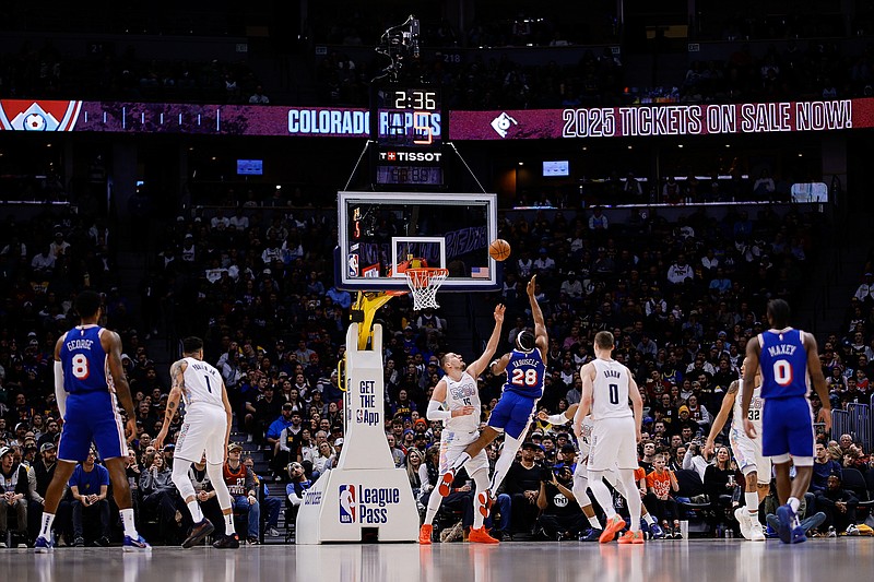 Jan 21, 2025; Denver, Colorado, USA; Philadelphia 76ers forward Guerschon Yabusele (28) drives to the basket against Denver Nuggets center Nikola Jokic (15) as forward Paul George (8) and forward Michael Porter Jr. (1) and guard Christian Braun (0) and guard Tyrese Maxey (0) look on in the first quarter at Ball Arena. Mandatory Credit: Isaiah J. Downing-Imagn Images