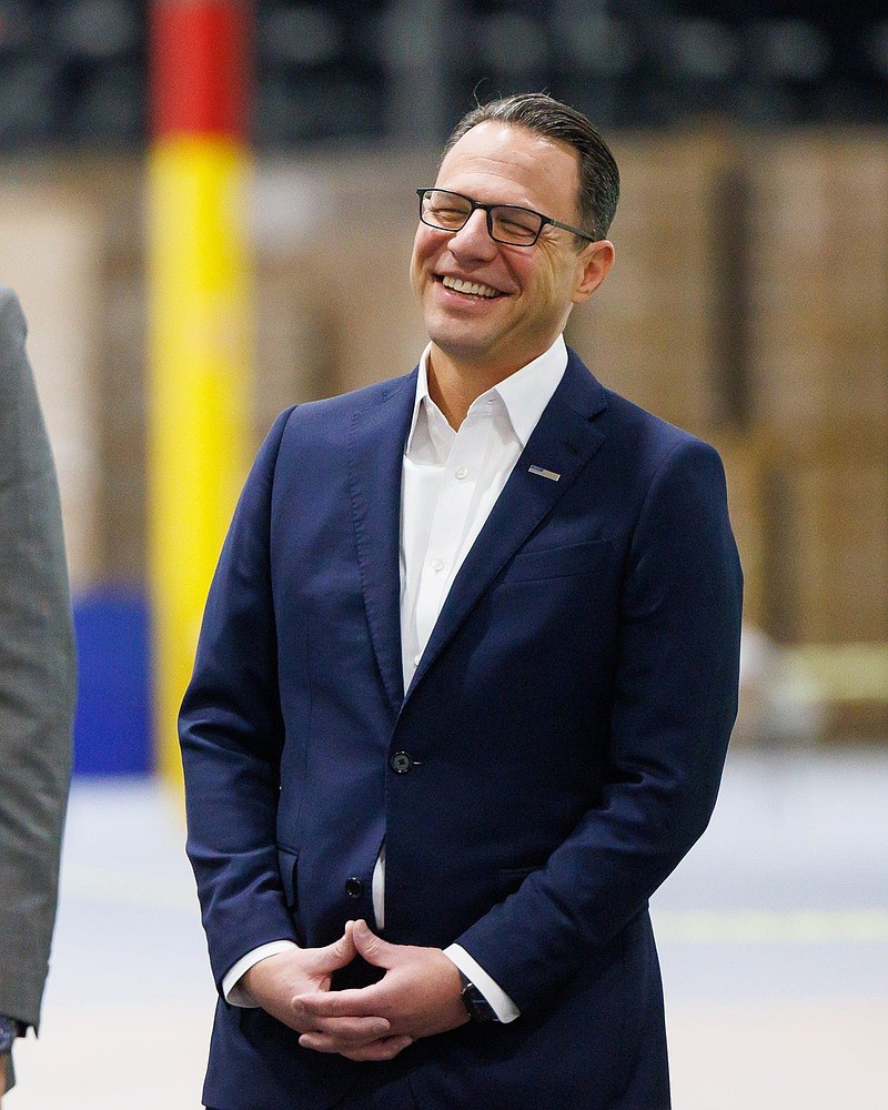 Pennsylvania governor Josh Shapiro laughs in response to Dylan Lissette, chairman of the board of directors for Utz Brands, as Lissette speaks during a ribbon-cutting ceremony for the new 650,000-square-foot Rice Distribution Center of Utz Brands, Inc., on Kindig Lane, Thursday, Dec. 5, 2024, in Conewago Township