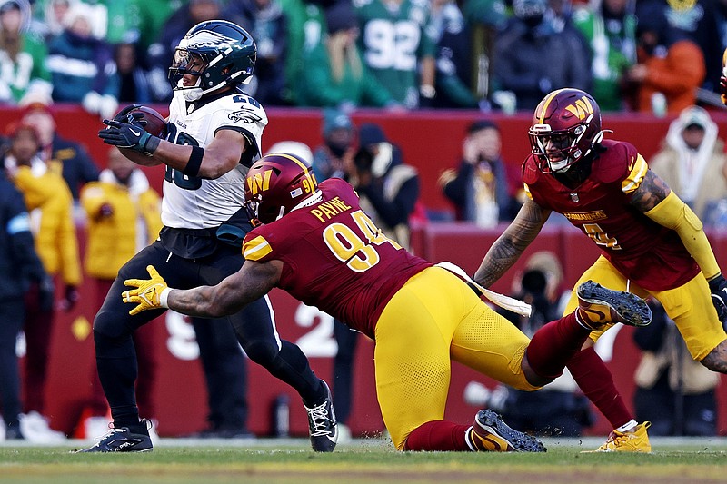 Dec 22, 2024; Landover, Maryland, USA; Philadelphia Eagles running back Saquon Barkley (26) runs the ball against Washington Commanders defensive tackle Daron Payne (94) during the third quarter at Northwest Stadium. Mandatory Credit: Peter Casey-Imagn Images