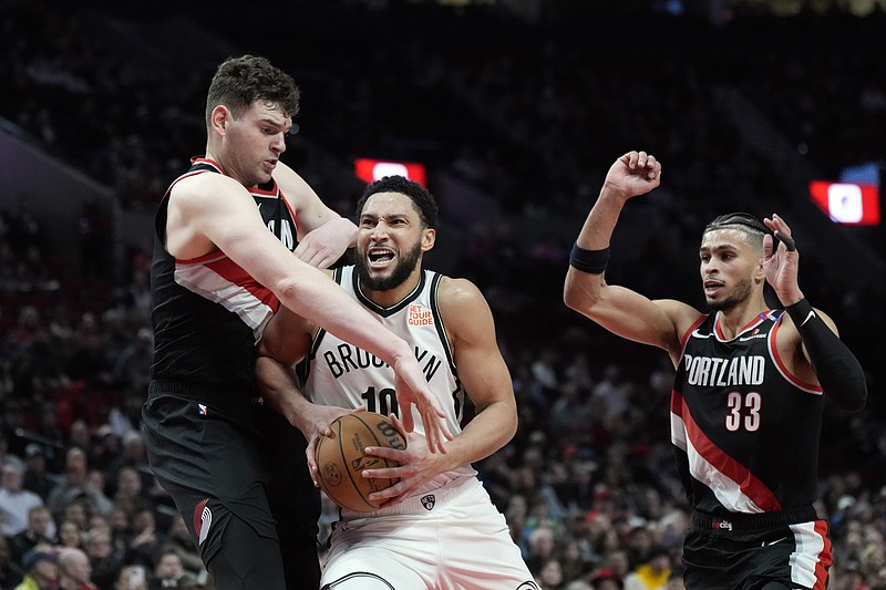 Jan 14, 2025; Portland, Oregon, USA; Brooklyn Nets point guard Ben Simmons (10) drives to the basket against Portland Trail Blazers center Donovan Clingan (23) during the first half at Moda Center. Mandatory Credit: Soobum Im-Imagn Images