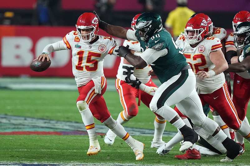 Feb 12, 2023; Glendale, Arizona, US; Kansas City Chiefs quarterback Patrick Mahomes (15) looks to pass under pressure from Philadelphia Eagles defensive tackle Jordan Davis (90) in the third quarter of Super Bowl LVII at State Farm Stadium. Mandatory Credit: Joe Camporeale-USA TODAY Sports