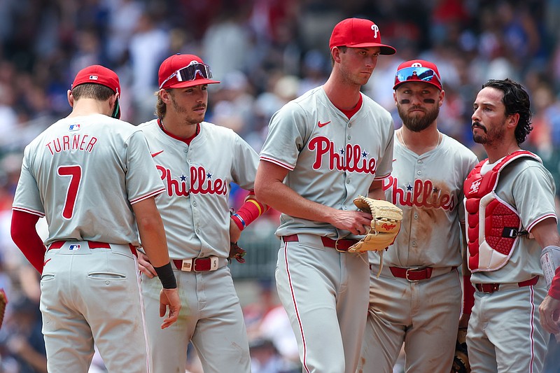 Jul 7, 2024; Atlanta, Georgia, USA; Philadelphia Phillies pitcher Michael Mercado (63) is removed from a game as shortstop Trea Turner (7) and second baseman Bryson Stott (5) and first baseman Kody Clemens (2) and catcher Garrett Stubbs (21) look on against the Atlanta Braves in the second inning at Truist Park. Mandatory Credit: Brett Davis-USA TODAY Sports