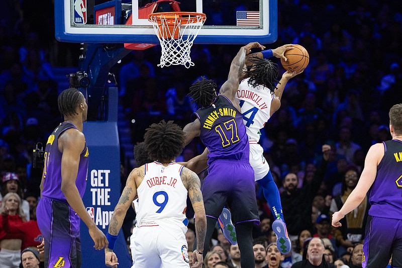 Jan 28, 2025; Philadelphia, Pennsylvania, USA; Philadelphia 76ers guard Ricky Council IV (14) is fouled while driving for a shot by Los Angeles Lakers forward Dorian Finney-Smith (17) during the second quarter at Wells Fargo Center. Mandatory Credit: Bill Streicher-Imagn Images