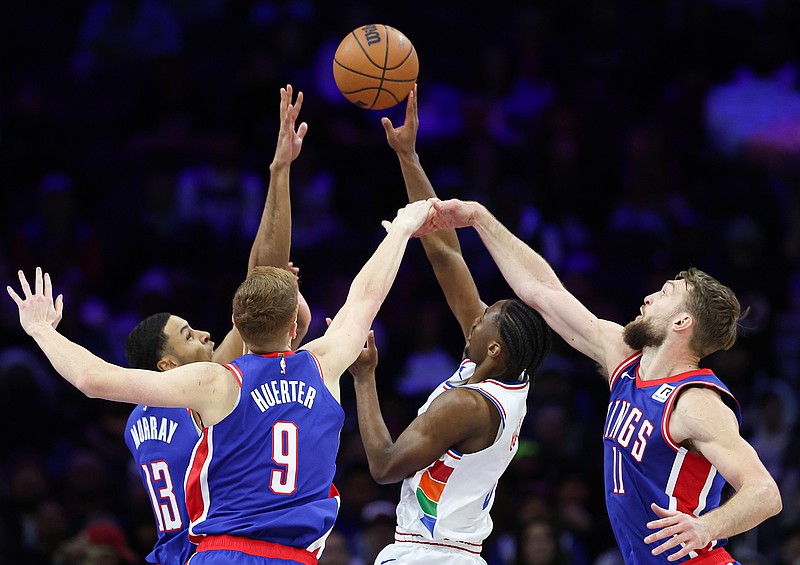 Jan 29, 2025; Philadelphia, Pennsylvania, USA; Philadelphia 76ers guard Tyrese Maxey (0) shoots between Sacramento Kings Domantas Sabonis (11) and Kevin Huerter (9) and Keegan Murray (13) during the second quarter at Wells Fargo Center. Mandatory Credit: Bill Streicher-Imagn Images