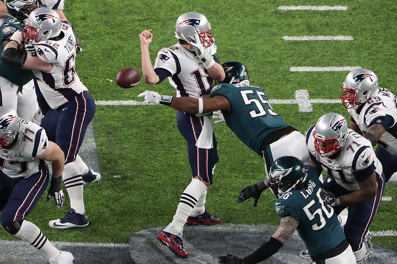 Feb 4, 2018; Minneapolis, MN, USA; New England Patriots quarterback Tom Brady (12) fumbles the ball as he is hit by Philadelphia Eagles defensive end Brandon Graham (55) during the fourth quarter in Super Bowl LII at U.S. Bank Stadium. Mandatory Credit: Kevin Jairaj-USA TODAY Sports