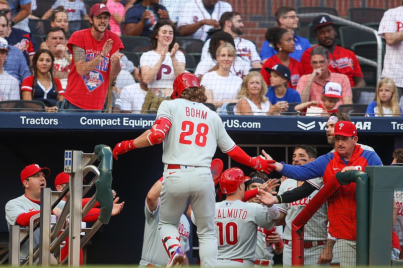 May 25, 2023; Atlanta, Georgia, USA; Philadelphia Phillies first baseman Alec Bohm (28) celebrates after a home run with manager Rob Thomson (59) against the Atlanta Braves in the second inning at Truist Park. Mandatory Credit: Brett Davis-USA TODAY Sports