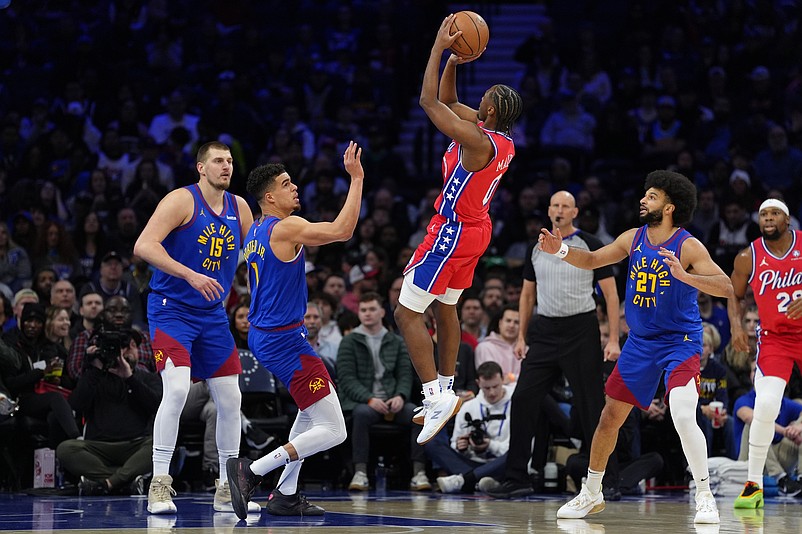 Jan 31, 2025; Philadelphia, Pennsylvania, USA; Philadelphia 76ers guard Tyrese Maxey (0) shoots the ball against Denver Nuggets forward Michael Porter Jr (1) in the first quarter at Wells Fargo Center. Mandatory Credit: Kyle Ross-Imagn Images