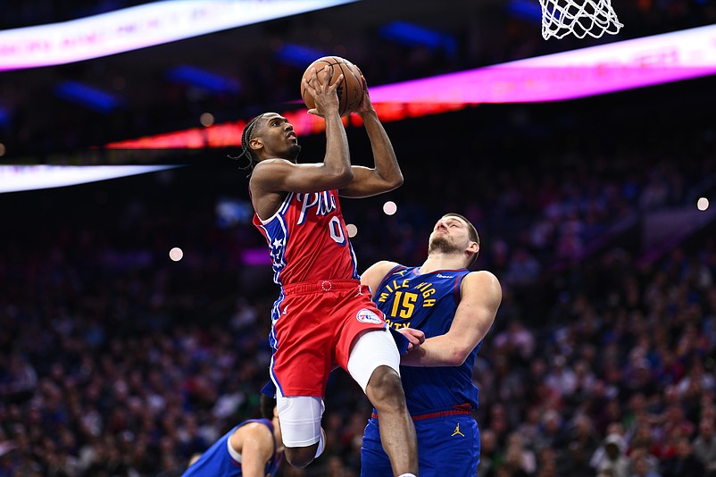 Jan 31, 2025; Philadelphia, Pennsylvania, USA; Philadelphia 76ers guard Tyrese Maxey (0) drives to shoot against Denver Nuggets center Nikola Jokic (15) in the fourth quarter at Wells Fargo Center. Mandatory Credit: Kyle Ross-Imagn Images