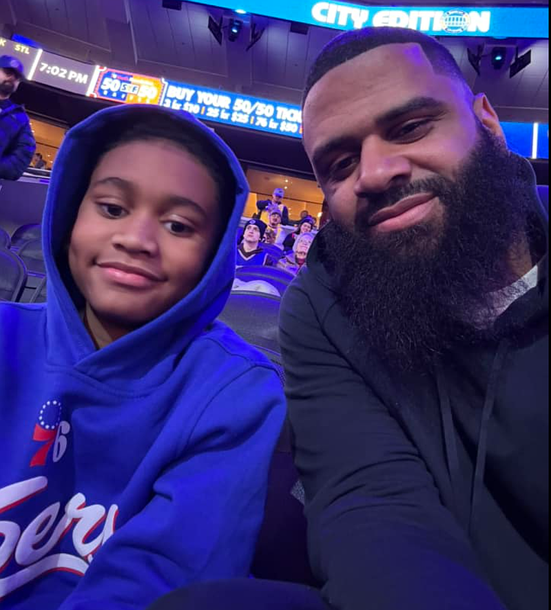 Andre "Trey" Howard and his dad Andre Howard Jr. at a Sixers game. Try was injured while in a car with his dad during the plane crash in Northeast Philly on Friday.