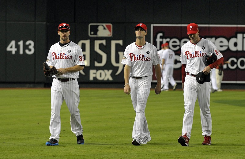 July 12, 2011; Phoenix, AZ, USA; National League pitchers Cliff Lee (left) , Cole Hamels (middle) and Roy Halladay of the Philadelphia Phillies walk off the field before the 2011 All Star game at Chase Field.  Mandatory Credit: Scott Rovak-USA TODAY Sports