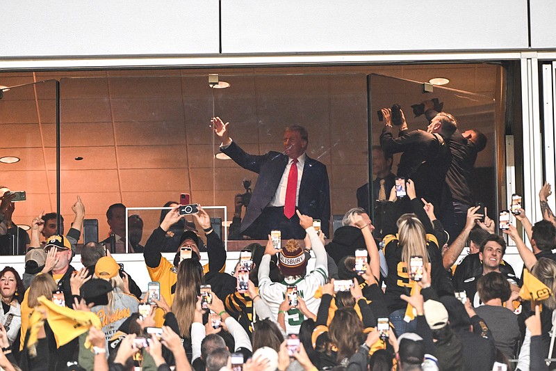 Oct 20, 2024; Pittsburgh, Pennsylvania, USA; Former President Donald Trump waves to the crowd during a game between the Pittsburgh Steelers and the New York Jets at Acrisure Stadium. Mandatory Credit: Barry Reeger-Imagn Images