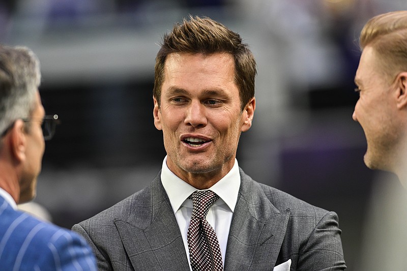 Dec 29, 2024; Minneapolis, Minnesota, USA;  FOX broadcaster and former NFL quarterback Tom Brady looks on before the game between the Minnesota Vikings and the Green Bay Packers at U.S. Bank Stadium. Mandatory Credit: Jeffrey Becker-Imagn Images