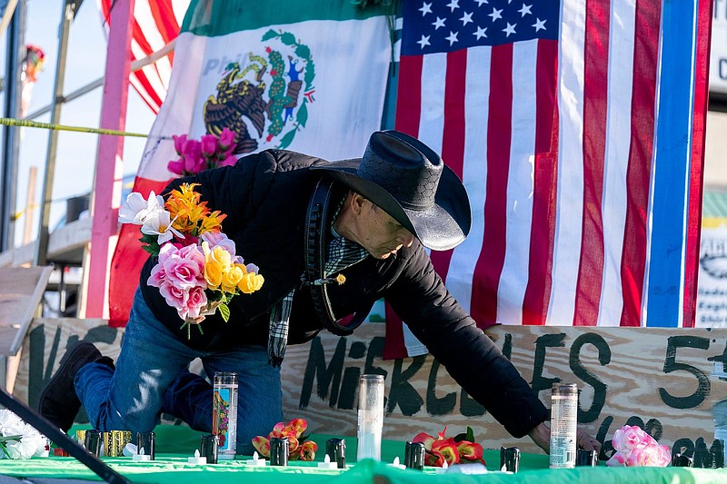 Roberto Marquez, from Dallas, Texas, sets up a vigil for those who lost their lives when a Learjett55 medical plane crashed last week at the intersection of Cottman Ave. and Bustleton Ave. in Northeast Philadelphia on Monday, Feb. 3, 2025.