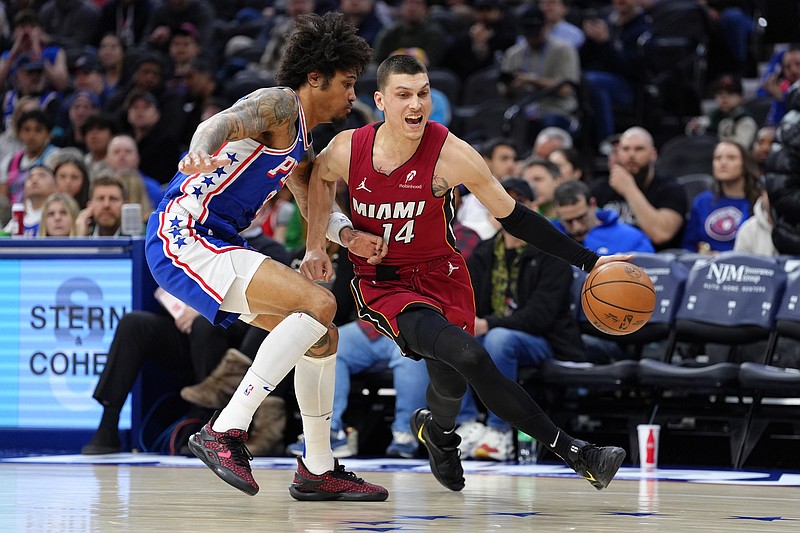 Feb 5, 2025; Philadelphia, Pennsylvania, USA; Miami Heat guard Tyler Herro (14) drives against Philadelphia 76ers guard Kelly Oubre Jr (9) in the first quarter at Wells Fargo Center. Mandatory Credit: Kyle Ross-Imagn Images