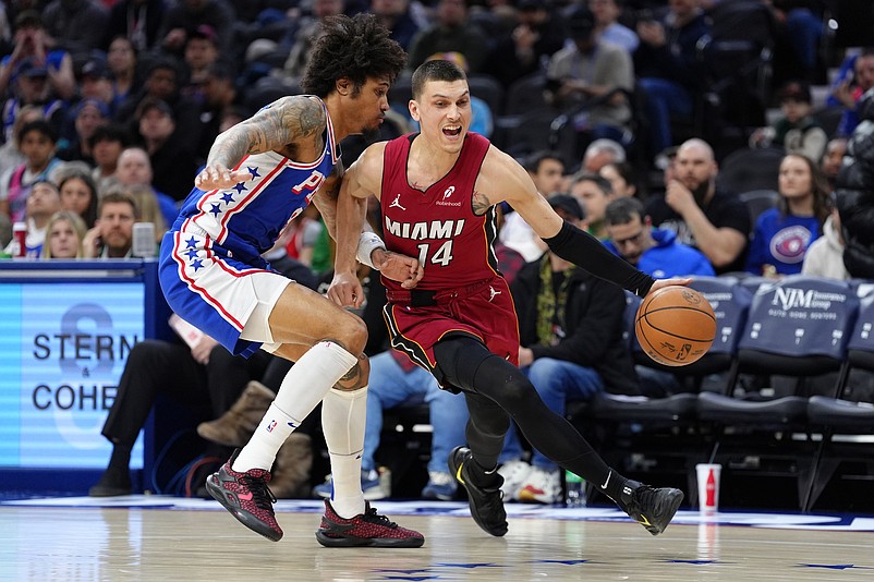 Feb 5, 2025; Philadelphia, Pennsylvania, USA; Miami Heat guard Tyler Herro (14) drives against Philadelphia 76ers guard Kelly Oubre Jr (9) in the first quarter at Wells Fargo Center. Mandatory Credit: Kyle Ross-Imagn Images