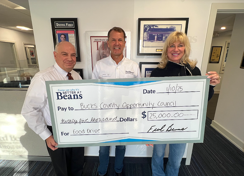 Bucks County Opportunity Council Director of Development Joe Cuozzo, left, accepts a donation from Fred Beans Automotive COO Chris Gilbert, center, and Vice President Beth Beans Gilbert. The automotive group donated $50,000 to hunger-fighting organizations following a year-end sales challenge that dedicated a portion of each sale to fund meals for community members facing food insecurity throughout Beans' areas of operation. (Credit: Fred Beans Automotive Group)