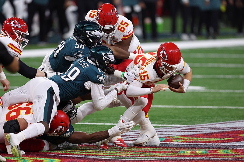 Feb 9, 2025; New Orleans, LA, USA; Philadelphia Eagles linebacker Jalyx Hunt (58) and linebacker Josh Sweat (19) tackle Kansas City Chiefs quarterback Patrick Mahomes (15) during the first half of Super Bowl LIX at Caesars Superdome. Mandatory Credit: Bill Streicher-Imagn Images