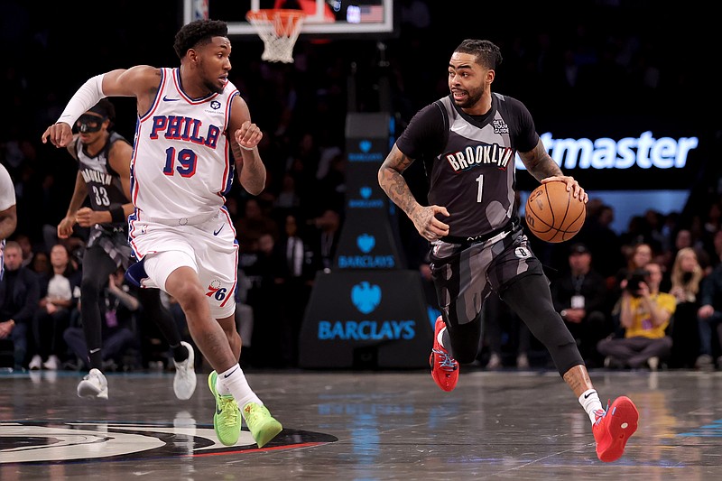 Feb 12, 2025; Brooklyn, New York, USA; Brooklyn Nets guard D'Angelo Russell (1) brings the ball up court against Philadelphia 76ers forward Justin Edwards (19) during the first quarter at Barclays Center. Mandatory Credit: Brad Penner-Imagn Images