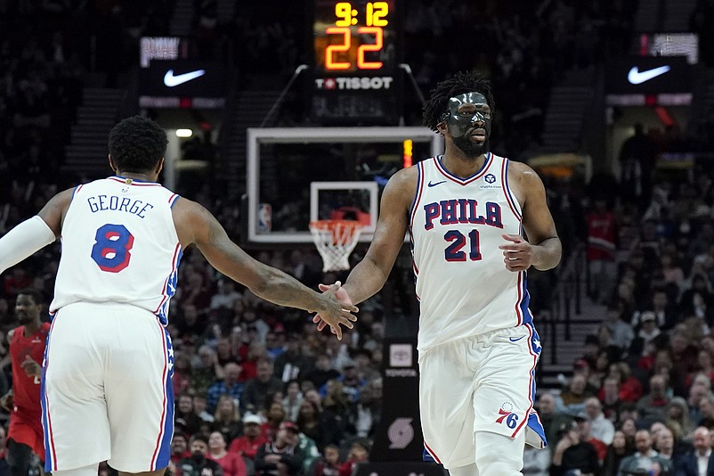 Dec 30, 2024; Portland, Oregon, USA; Philadelphia 76ers center Joel Embiid (21) and forward Paul George (8) high five during the second half against the Portland Trail Blazers at Moda Center. Mandatory Credit: Soobum Im-Imagn Images